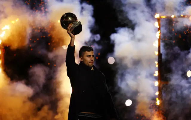 Rodri holds up his ballon dor trophy