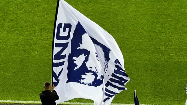 Picture of a flag with the image of Carlos Corberan and words 'King Carlos'