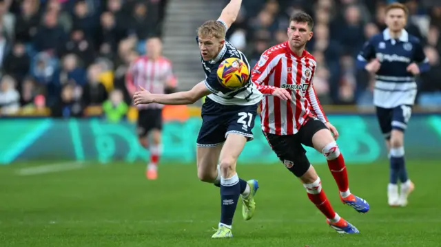 Millwall forward Josh Coburn (21) under pressure from Sunderland defender Chris Mepham (26)