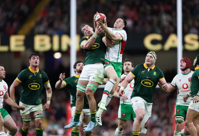 Owen Watkin of Wales and Cameron Hanekom of South Africa compete for the ball