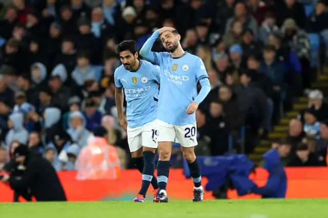 Ilkay Guendogan and Bernardo Silva of Manchester City look dejected