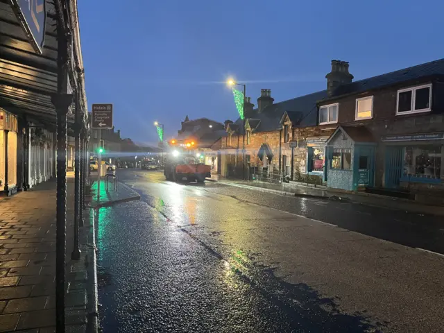 Gritter on wet road in Pitlochry