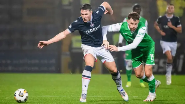 DUNDEE, SCOTLAND - NOVEMBER 23: Dundee's Josh Mulligan and Hibernian's Jack Iredale in action during a William Hill Premiership match between Dundee and Hibernian at the Scot Foam Stadium at Den's Park on November 23, 2024, in Dundee, Scotland. (Photo by Euan Cherry / SNS Group)