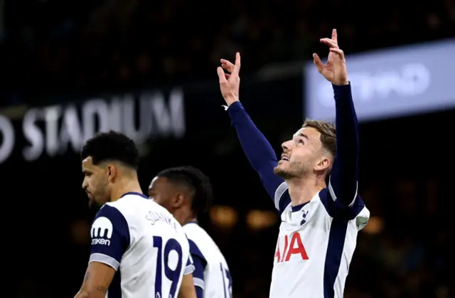 Maddison points to the sky in celebration