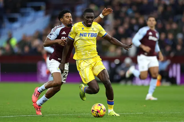 : Ismaila Sarr of Crystal Palace holds off Ian Maatsen