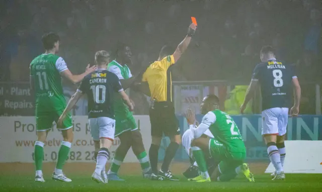 DUNDEE, SCOTLAND - NOVEMBER 23: Hibernian's Jordan Obita is shown a red card during a William Hill Premiership match between Dundee and Hibernian at the Scot Foam Stadium at Den's Park on November 23, 2024, in Dundee, Scotland. (Photo by Euan Cherry / SNS Group)