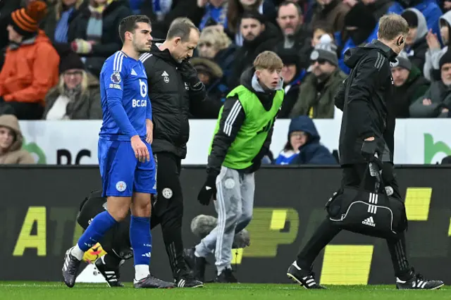 Harry Winks (L) leaves the game having picked up an injury