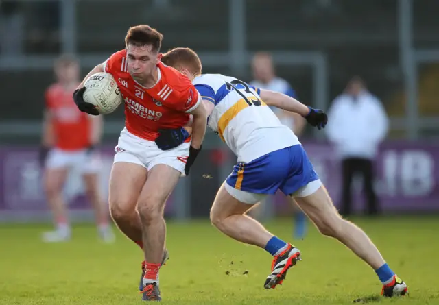 Errigal Ciaran's Peter Harte tackles Dan McCarthy
