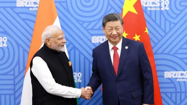 Indian Prime Minister Narendra Modi and Chinese President Xi Jinping shaking hands at the BRICS summit in 2024