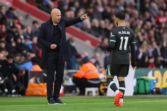 Slot gives orders to his team as Salah looks on