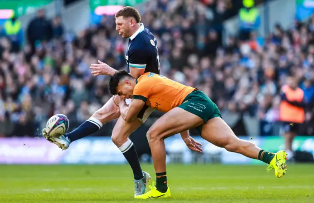 Finn Russell under pressure from Australia's Joseph-Aukuso Suaalii