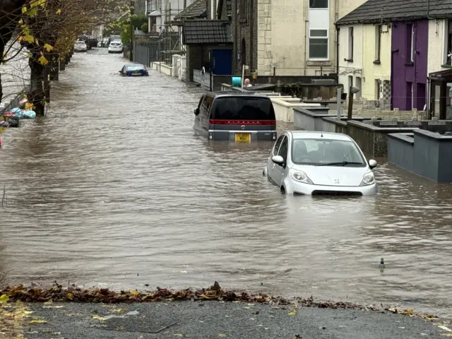 Cars on a flooded road in south Wales valleys