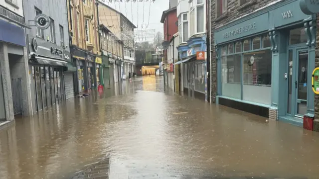 Flooded street in Pontypridd Wales. High water can be seen reaching shops and doors