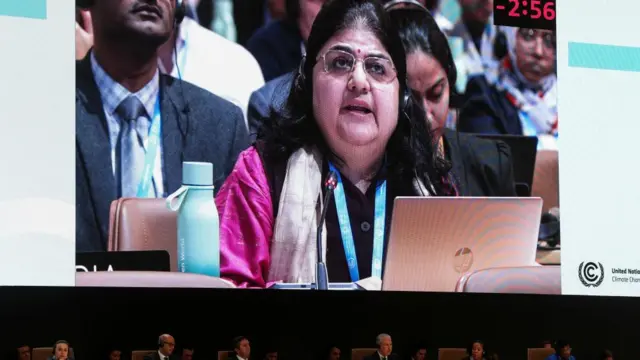 A screen displays Chandni Raina of India, as she speaks during a closing plenary meeting at the COP29 United Nations Climate Change Conference, in Baku