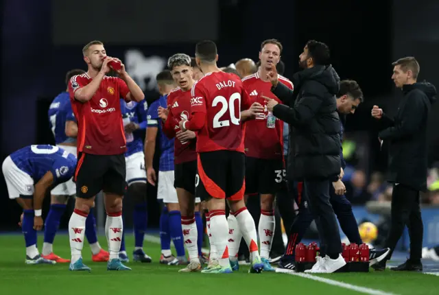 Amorim briefs his players on the touchline during a stoppage in play