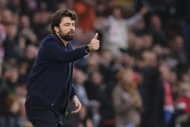 Martin puts thumbs up to his players from his technical area