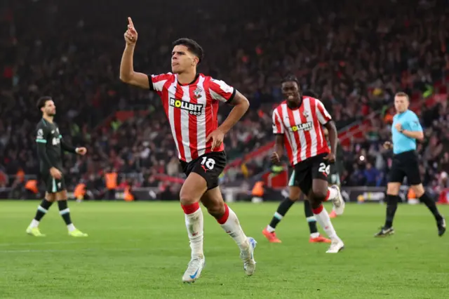 Fernandes pumps his fist to the fans in celebration