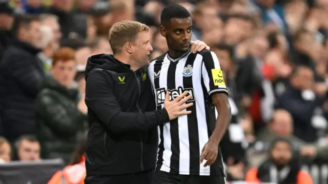 Newcastle player Alexander Isak is embraced by Eddie Howe