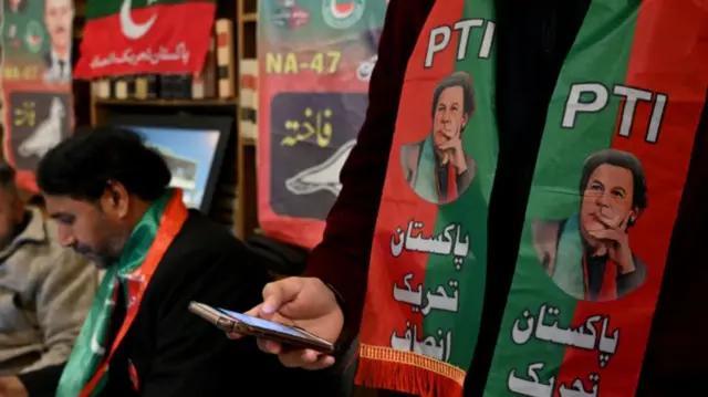 Imran Khan's supporters wear scarves with prints of his face