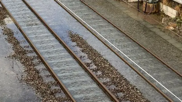 Railway like with Water between the tracks. The top of the tracks is above the surface of the water.