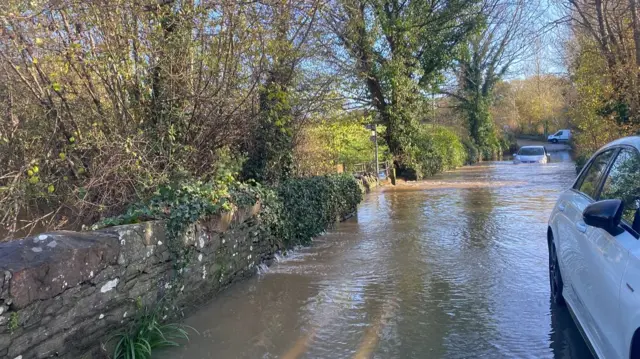 Cars driving through flood water