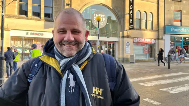 Colin Sutton pictured outside of a shopping centre in Chippenham wearing a thick Helly Hansen coat and scarf