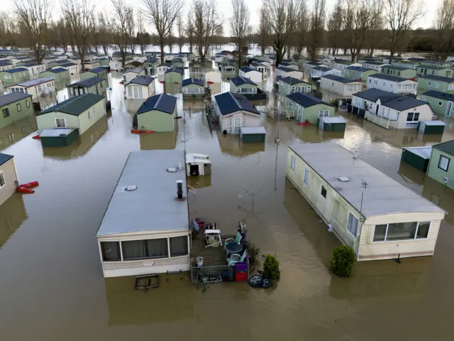 dozens of flooded caravans at Billing Aquadrome Holiday Park near Northampton as seen from above.