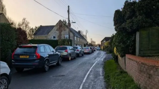 Cars queueing along a small country road in Tintinhull near Yeovil