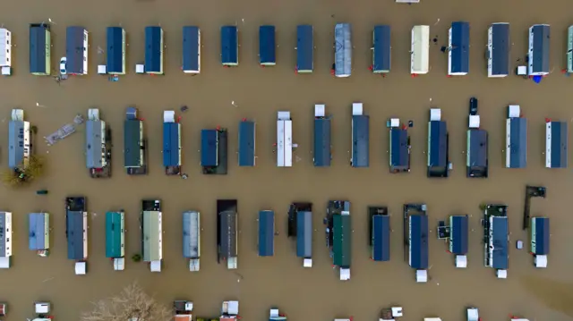 dozens of flooded caravans at Billing Aquadrome Holiday Park near Northampton as seen from above.