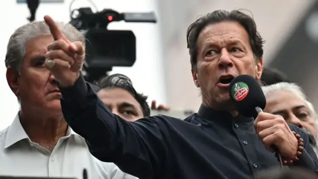 Imran Khan addresses his supporters during an anti-government march towards capital Islamabad, demanding early elections, in Gujranwala on November 1, 2022