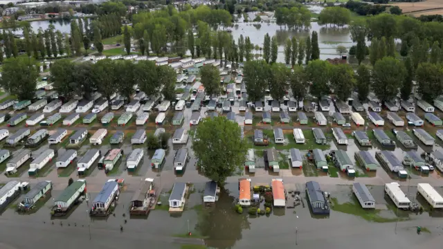 Rows of static homes surrounded by deep flood water