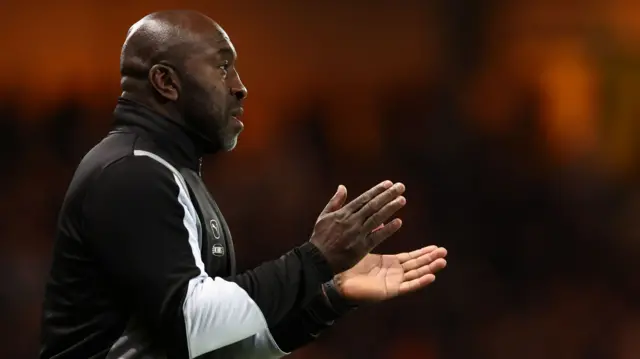 Port Vale manager Darren Moore applauds his team