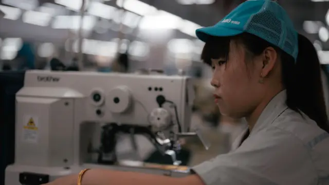 A woman works in the Hualida clothing factory in Changzhou, Jiangsu Province, China, 14 November 2023. The Hualida Clothing factory's main products are down jackets and functional sports and leisure tops. The products are exported to 38 countries and regions. Clothing manufacturing in China, Changzhou