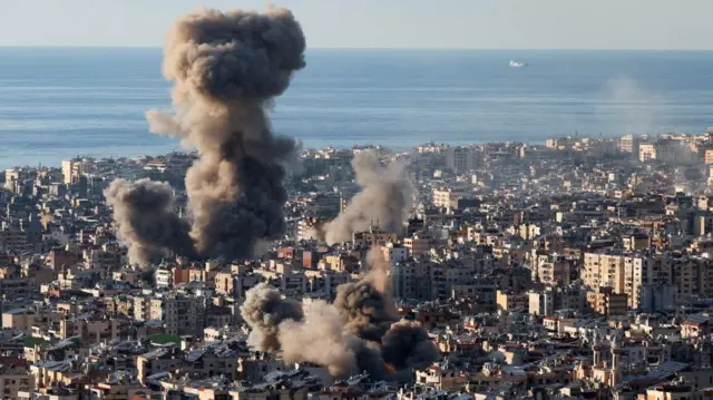 Smoke billows high into the sky from buildings in Beirut