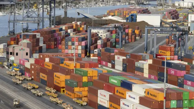 A terminal at the Port of Los Angeles, with hundreds of large multi-coloured shipping containers piled high