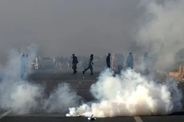 Policemen fire tear gas shells to disperse supporters of Pakistan Tehreek-e-Insaf (PTI) party during a protest to demand the release of former prime minister Imran Khan, in Islamabad on November 26, 2024.