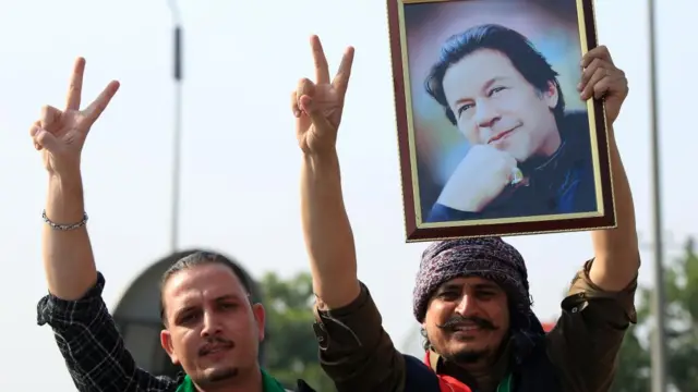 Supporters of the Pakistan Tehreek-e-Insaf (PTI) hold a portrait of the party's founder and former Prime Minister Imran Khan, as they take part in a rally towards Islamabad to demand release of Imran Khan's, in Peshawar, Pakistan, 24 November 2024.