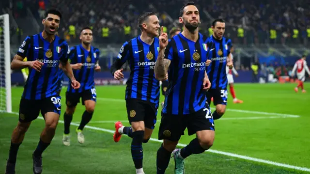 Hakan Calhanoglu of Inter Milan celebrates with team-mates after scoring