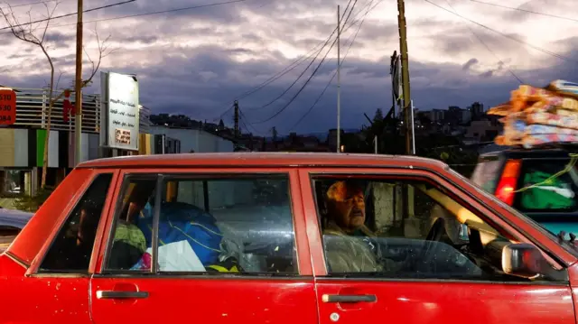 A man looking out his car window