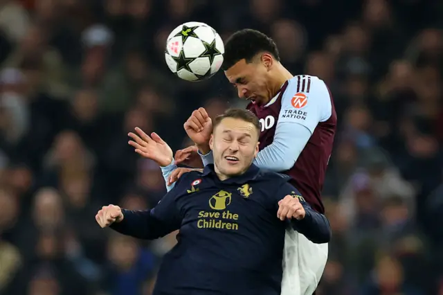 Teun Koopmeiners of Juventus competes for a header with Morgan Rogers of Aston Villa