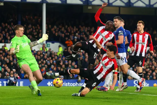 Christian Norgaard challenges Everton goalkeeper Jordan Pickford for the ball