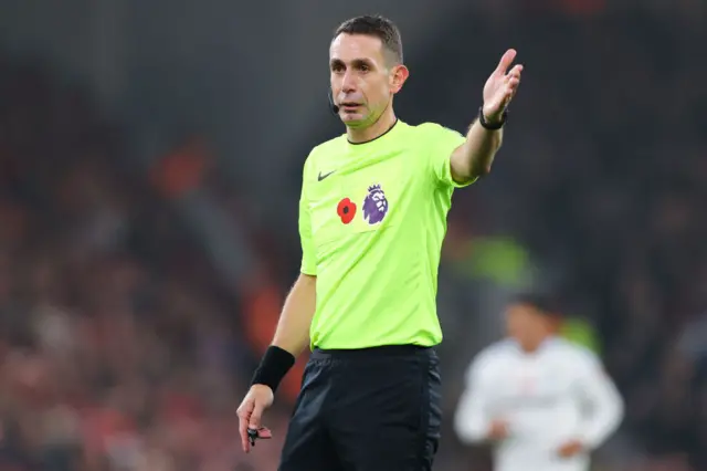 Referee David Coote signalling during a match