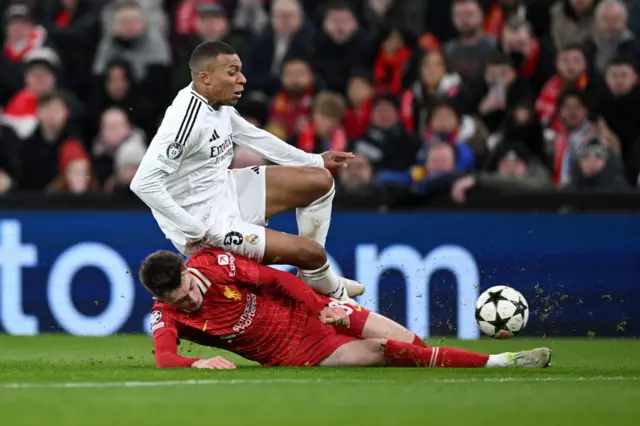 Conor Bradley tackles Kylian Mbappe