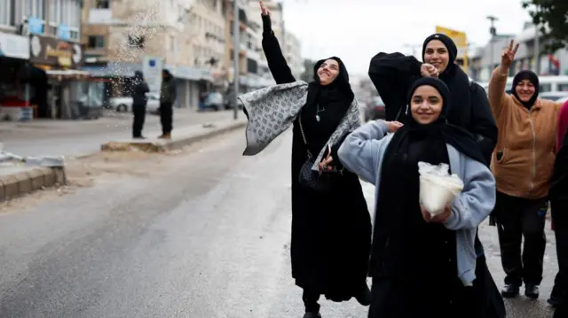 Women welcome the people coming back to Tyre