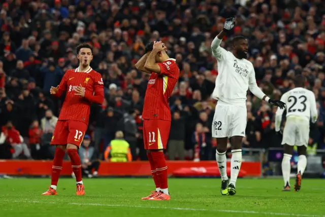 Salah holds his head after missing a penalty