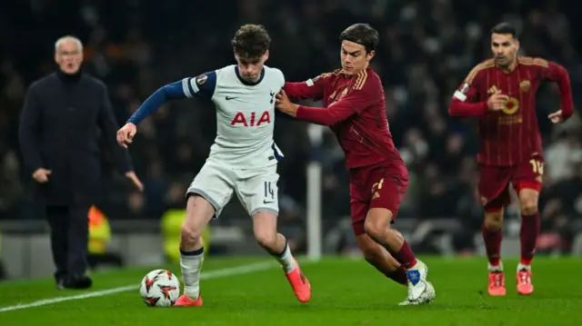 Archie Gray of Tottenham Hotspur and Paulo Dybala of Roma battle for the ball