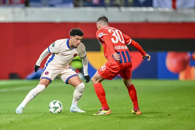 Jadon Sancho of and Norman battle for the ball