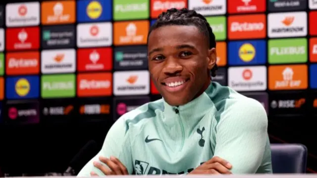 Tottenham defender Destiny Udogie speaking at a news conference