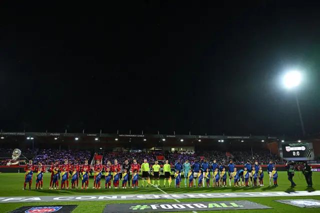 Players line up on the pitch ahead of kick-off