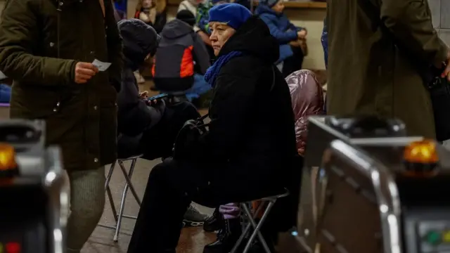 People taking shelter inside a Kyiv metro station. Many of them are wrapped up in winter gear